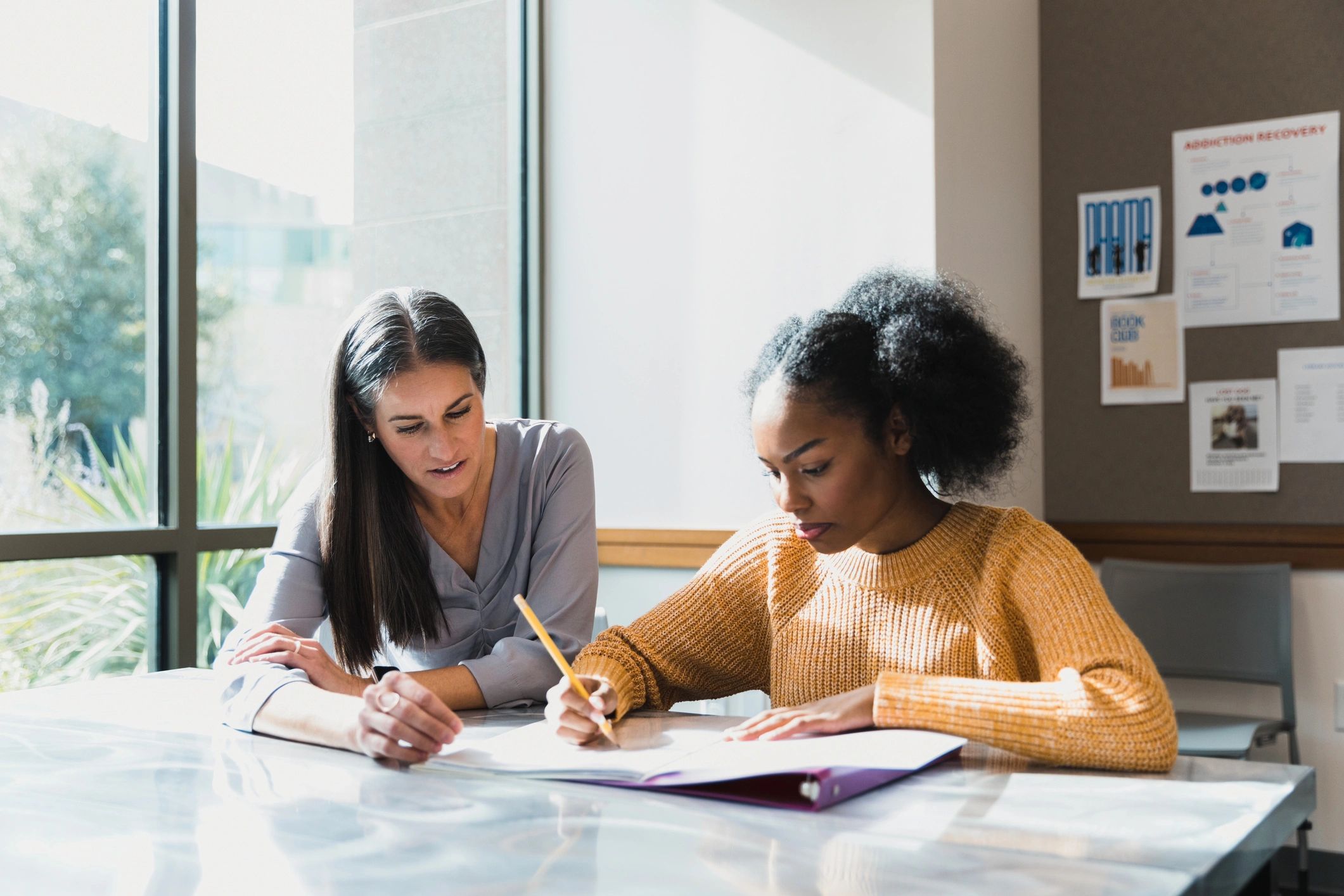 Tutor working one-on-one with a high school student
