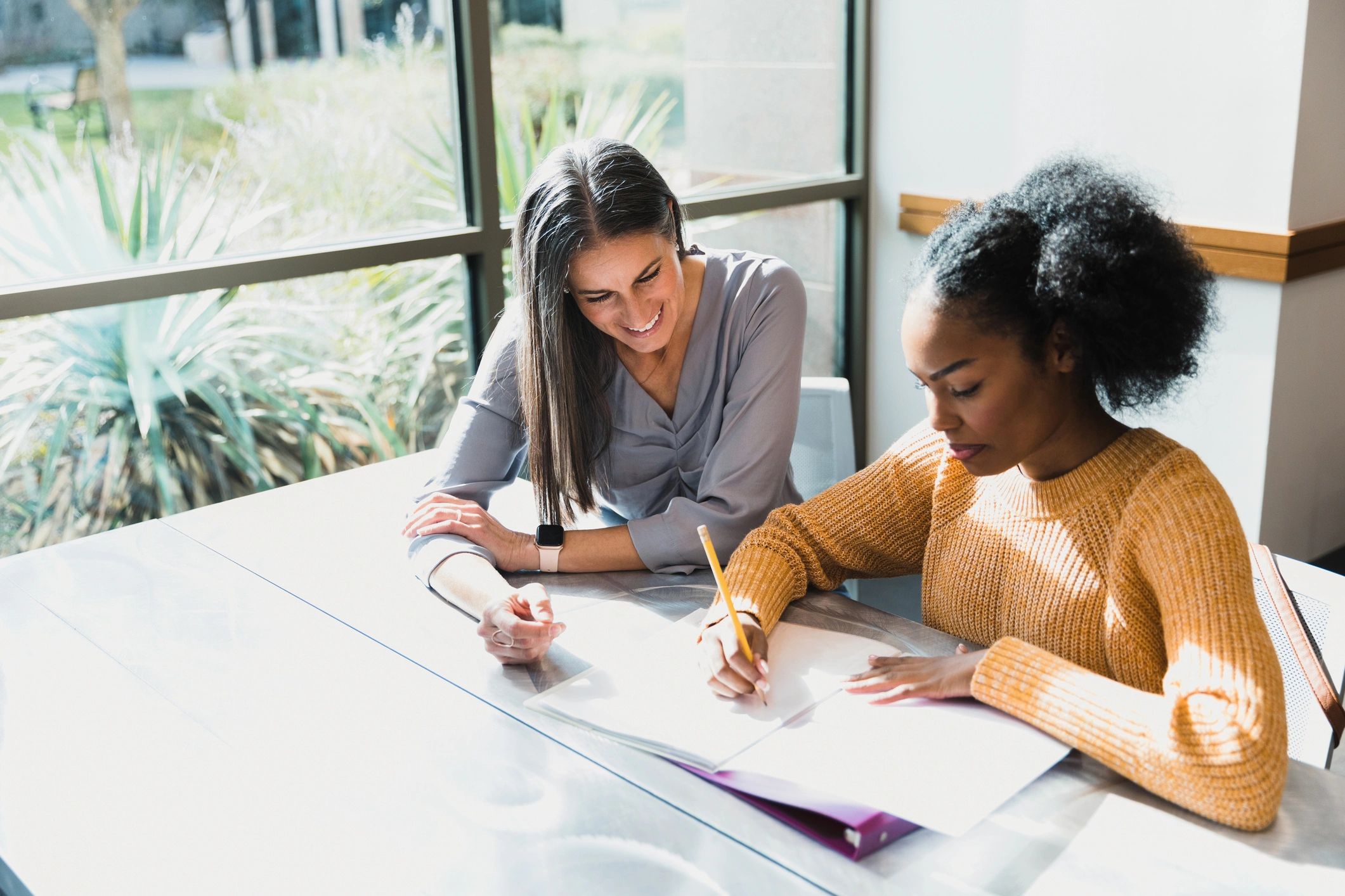 Friendly tutor supporting a student during a session