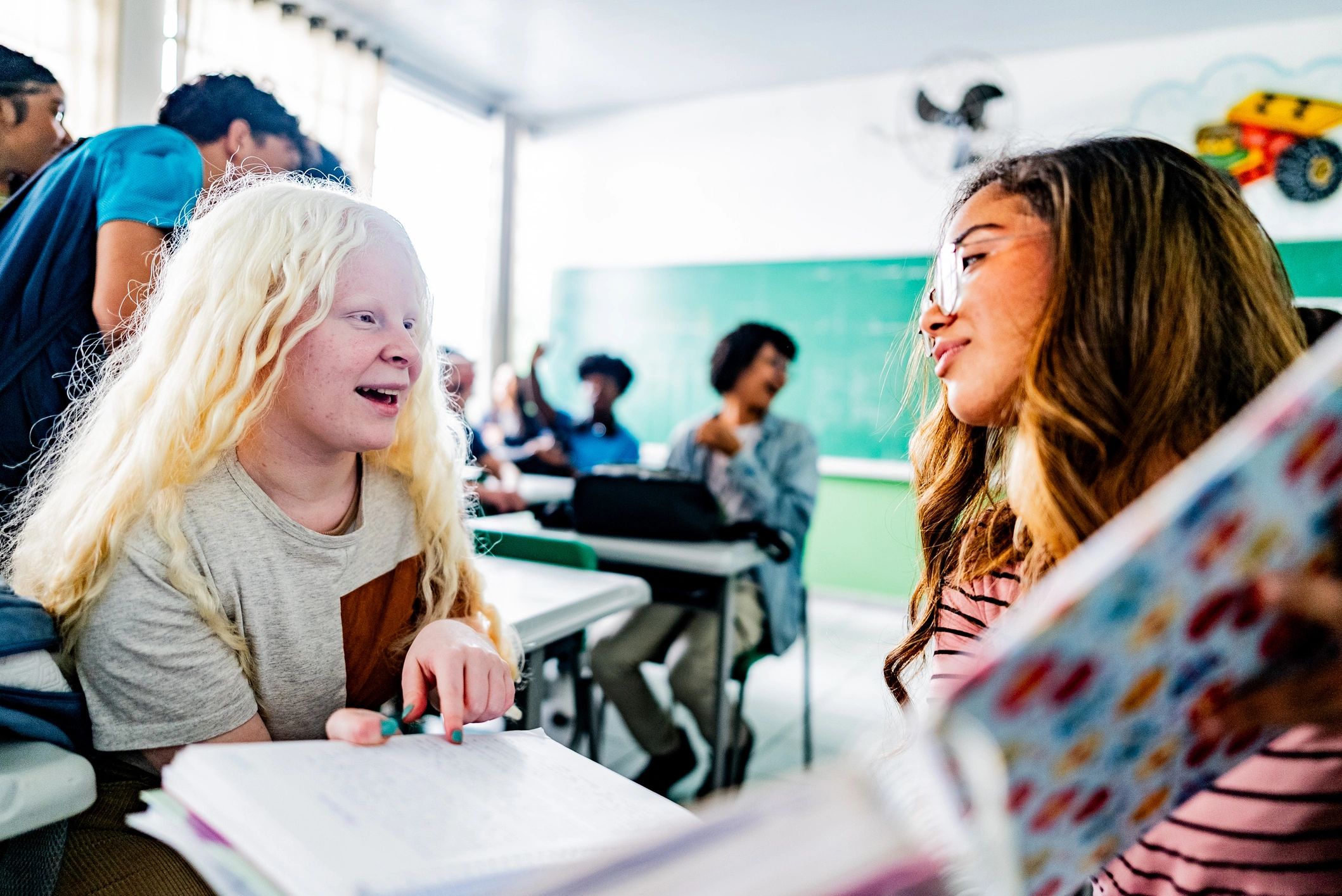 High school students talking together in a classroom