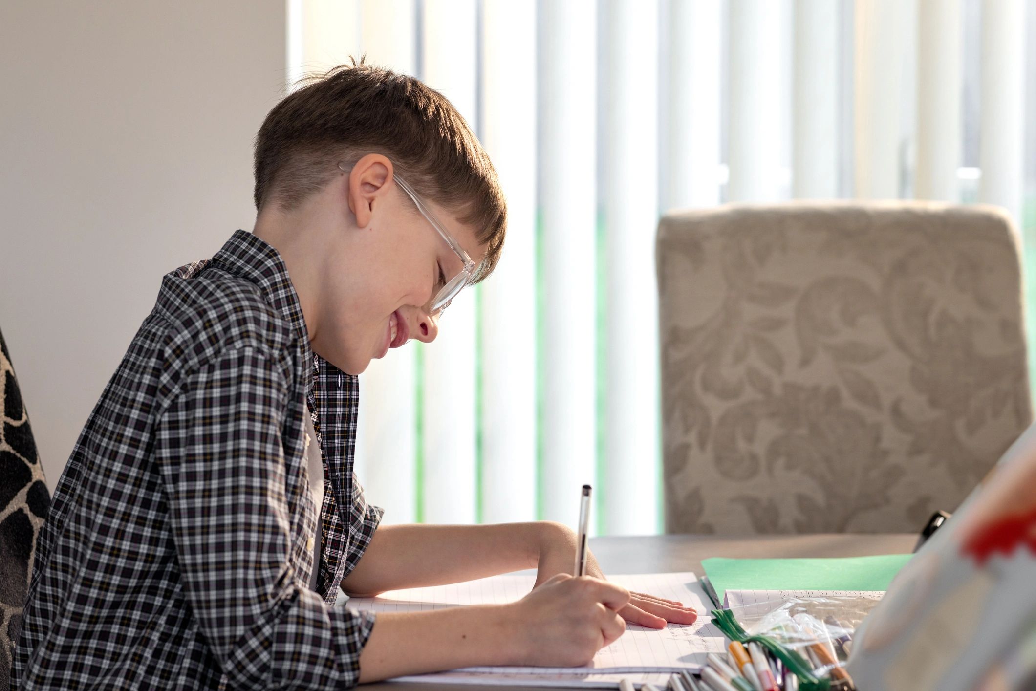 Young boy concentrating on homework at a desk