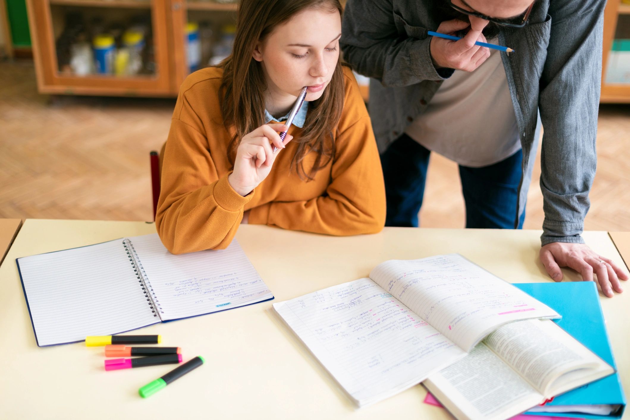 Teacher helping a high school student with study work